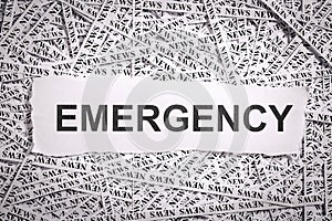 Closeup torn pieces and tapes of paper with the word EMERGENCY.