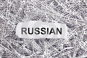 Closeup torn pieces and tapes of paper with the word RUSSIAN.