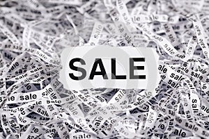 Closeup torn pieces and tapes of paper with the word SALE. Black