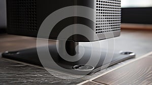 A closeup of the tower fans stand featuring a and stable base with rubberized feet for added grip