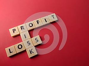 Closeup toys letters with the word PROFIT RISK LOSS