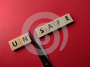 Closeup toys letters with the word UNSAFE