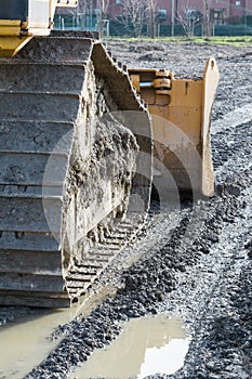 Closeup of tracked loader excavator at construction area