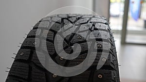 Closeup tracking shot of new rubber tire in dealership office. Close up of new modern car tyre for automobile wheel at