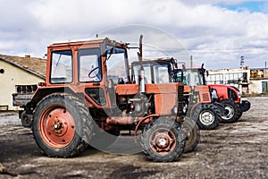Closeup of tractors after plowing. Wheels covered with mud. Agr