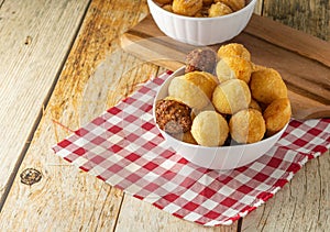 Closeup of traditional brazilian party snack mix with coxinha, kibe, and other fried snacks on table