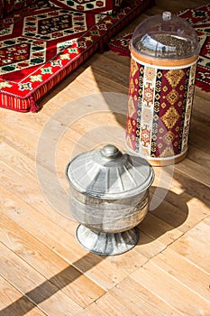 Closeup of traditional canisters with Aztec geometric design on a wooden table