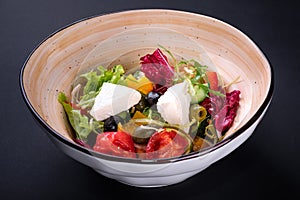 Closeup traditional greek salad with fresh vegetables, feta cheese, olives and olive oil in a bowl. Top view. Rustic style.