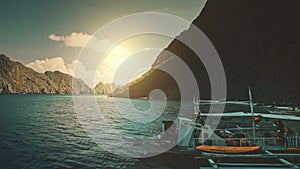 Closeup traditional passenger boat at sand ocean coast aerial view. Mountain island sun silhouette