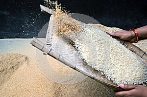 Closeup of traditional winnowing tool to separate bran or husk from the paddy, rice or seeds or other harvest.