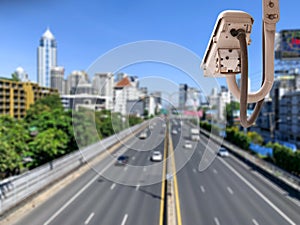 Traffic camera observes vehicular traffic on a road photo