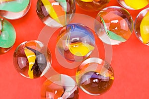 Closeup of transparent glass balls on a red background