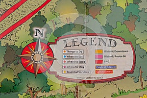 Closeup of travel map with legend and wind rose in form of a compass