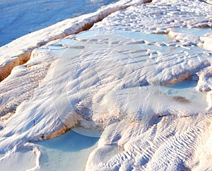 Closeup of travertine pools and terraces in Pamukkale, Turkey. Traveling abroad for vacation and tourism. Cotton castle