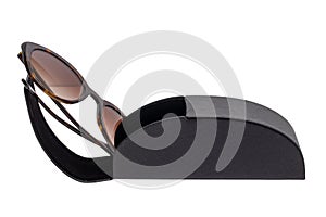 Closeup of trendy sun glasses in a opened black luxury leather spectacel hard isolated on a white background. Clipping path. Macro