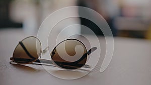 Closeup on trendy sunglasses on table in cafe