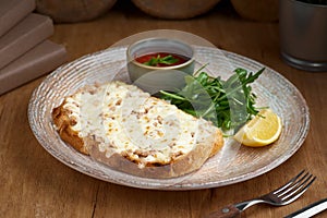 Closeup of a tuna melt topped with cheddar cheese