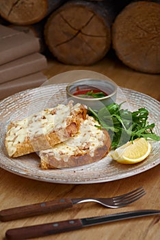 Closeup of a tuna melt topped with cheddar cheese