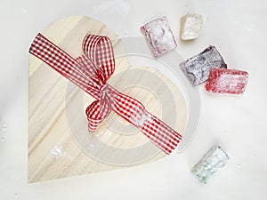 Closeup of turkish delight with a heart shaped gift box tied wi