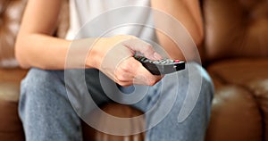 Closeup tv remote control in female hands