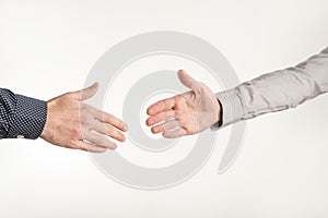 Closeup of two businessmen about to shake hands