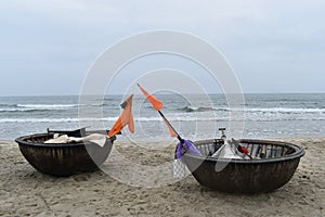 Closeup of two coconut boats on a lonely beach in Hoi An, Vietnam, Asia