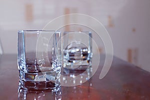 Closeup two cups of empty glass of whiskey