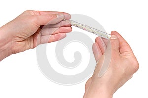 Closeup of two hands holding traditional thermomet