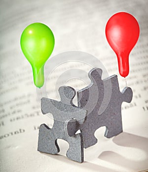 Closeup of Two Jigsaw Puzzle Pieces on Page of a Book