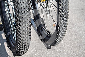 Closeup of two mountain bike wheel tires on grey background. Travel together. Trip on bicycle trail in a park