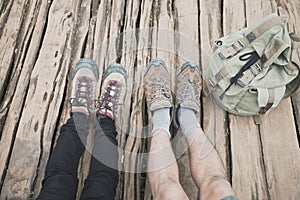 Closeup two pairs of feet in hiking shoes stick out.Two pairs of