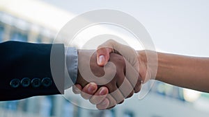 Closeup two people diverse multiracial man woman shake hands conclude successful contract agreement support partnership