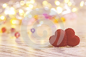 Closeup of two red hearts on wooden table