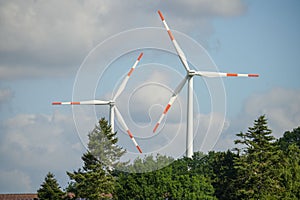 Closeup of two red and white windmills