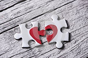 Puzzle pieces which form a heart photo