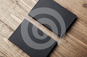 Closeup of two stack Of blank black business cards on wooden background