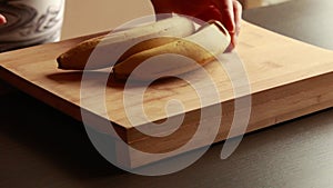 CloseUp: Two Unpeeled Bananas on Wooden Cutting Board