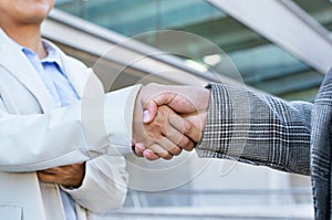 Closeup Of Two Unrecognizable Business People Handshaking Outdoor Office Building