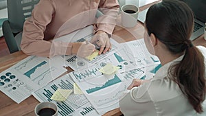 closeup two young enthusiastic businesswoman work in office with report paper.