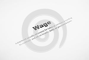 Closeup of a typed definition of the word wage.