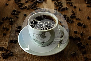 Closeup of Typical Brazilian Coffee Cup and Coffee Beans on a Wooden Table