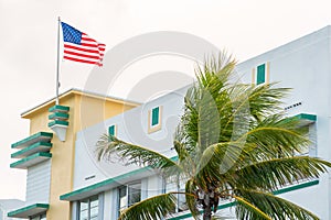 Closeup of typical colorful Art Deco architecture with tropical palm tree on Ocean Drive in South Beach, Miami, Florida