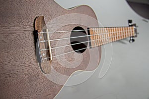 Closeup of an Ukelele with a gray background