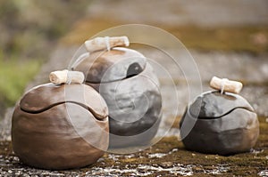 Closeup of unique handmade three pots with wooden details