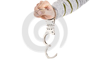 Closeup of unlocked handcuffs hanging on man hand