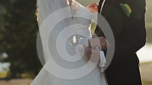 Closeup unrecognizable young man and woman holding hands. Unknown newlywed couple standing after exchanging rings. Happy