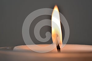 Closeup up of top of pillar candle and burning flame