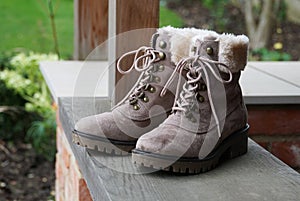 Closeup up of winter fur lined brown boots outdoors