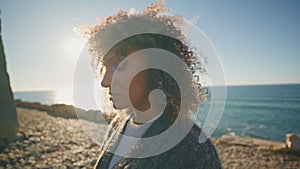 Closeup upset girl looking distance at sea beach. Sd woman face with windy hair