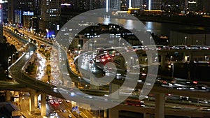 Closeup of urban traffic on overpass interchange at night,time lapse.